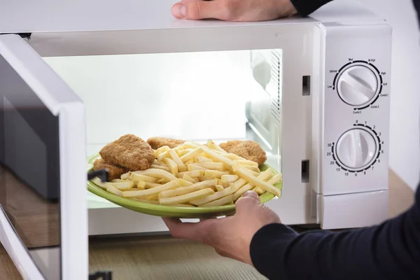 Close Person Hand Putting Fried Food Microwave Oven — Stock Photo, Image