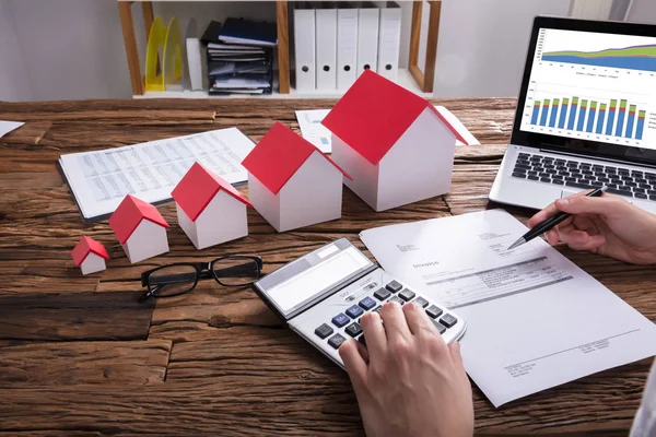 Close Businessperson Hand Calculating Bill House Model Laptop Desk — Stock Photo, Image