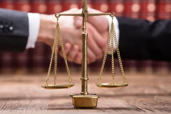 Close Justice Scale Wooden Desk Front Businesspeople Shaking Hands — Stock Photo, Image