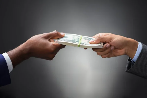 Close Two Business People Hand Holding Bundle Banknotes Gray Background — Stock Photo, Image