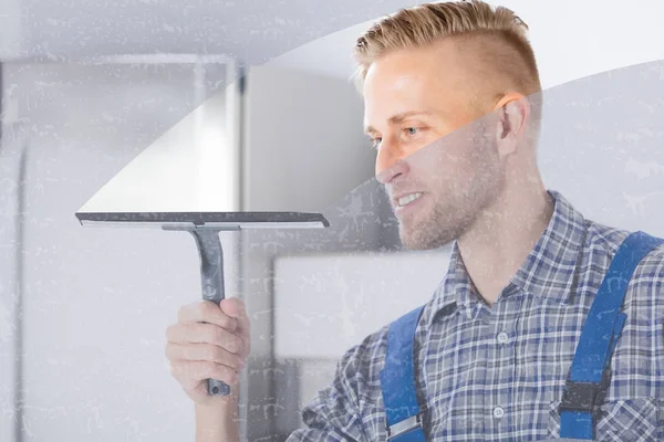 Smiling Young Worker Cleaning Glass Window Squeegee Kitchen — стоковое фото