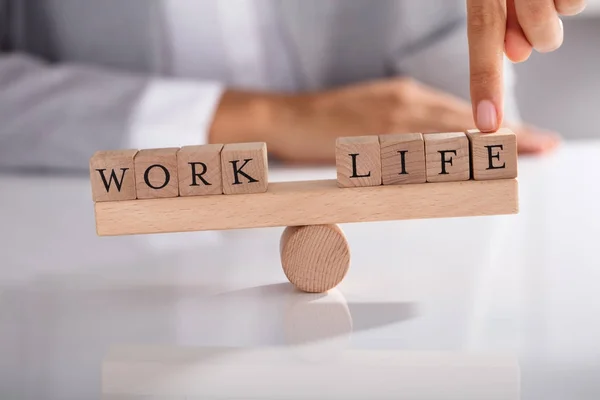 Close Businessperson Finger Showing Imbalance Work Life Wooden Seesaw — Stock Photo, Image
