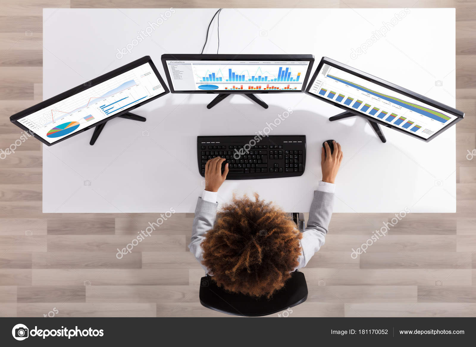 Businesswoman Analyzing Graph Multiple Computers Desk Office