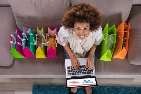 Happy Young Woman Using Laptop Multi Colored Shopping Bags Carpet — стоковое фото