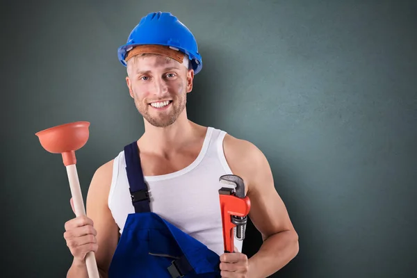 Portrait Happy Plumber Holding Wrench Plunger Grey Background — Stock Photo, Image