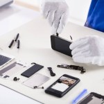 stock-photo-close-human-hand-repairing-smartphone