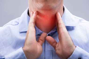 Close-up View Of A Man With Pain On His Neck Over The White Background clipart