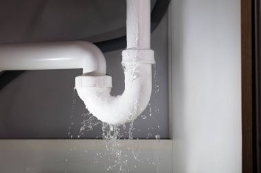 Close-up Of Water Is Leaking From The White Sink Pipe clipart