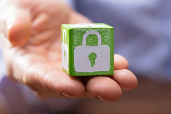 Close Hand Holding Green Wooden Block White Lock Symbol — Stock Photo, Image