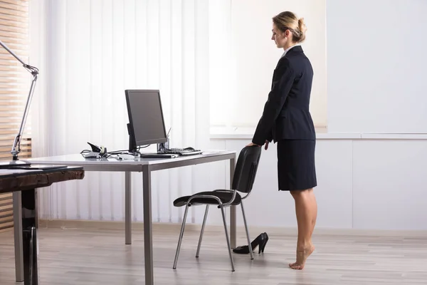 Ung Affärskvinna Stretching Hennes Ben Arbetsplatsen — Stockfoto