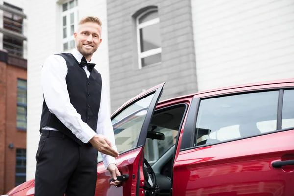 Portrait Handsome Young Male Valet Opening Red Car Door — Stock Photo, Image