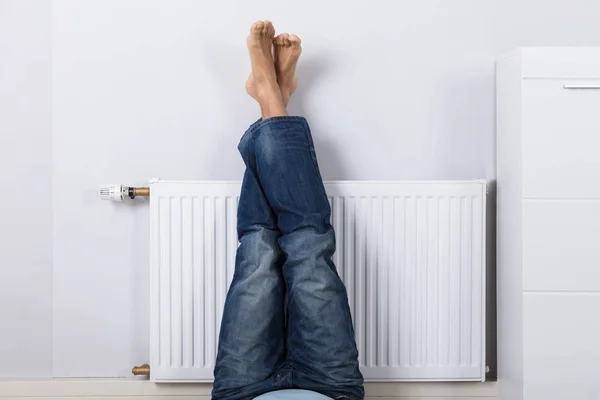 Man Warming His Feet White Radiator Home — Stock Photo, Image