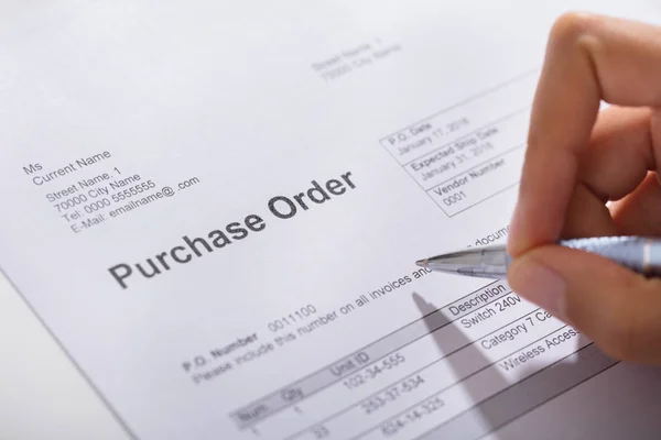 Close Person Hand Filling Purchase Order Form Wooden Desk Royalty Free Stock Photos