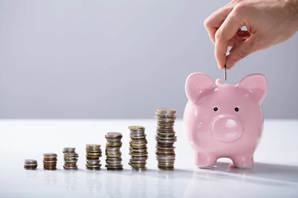 Person Hand Inserting Coin Piggybank Increasing Coins Stack Desk — Stock Photo, Image