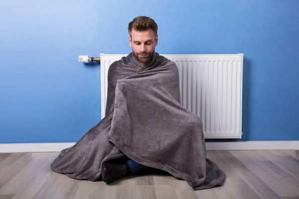 Young Man Wrapped Blanket Sitting Front Heater Home — Stock Photo, Image