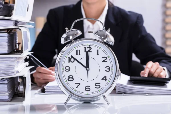 Businessperson Working Office Clock Stacked Folders Desk — Stock Photo, Image