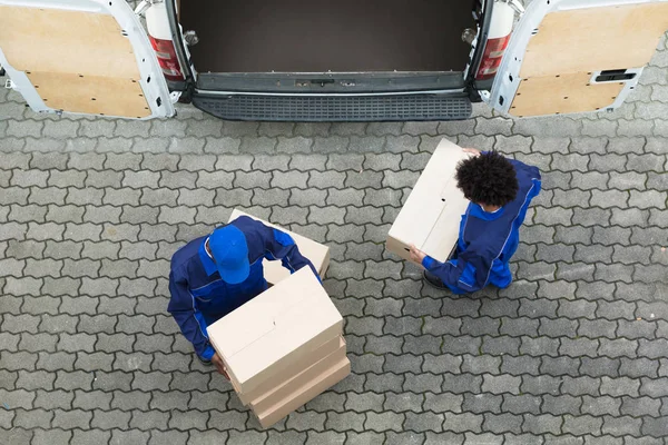 送货人从卡车上卸下纸板箱的高角度视角 — 图库照片