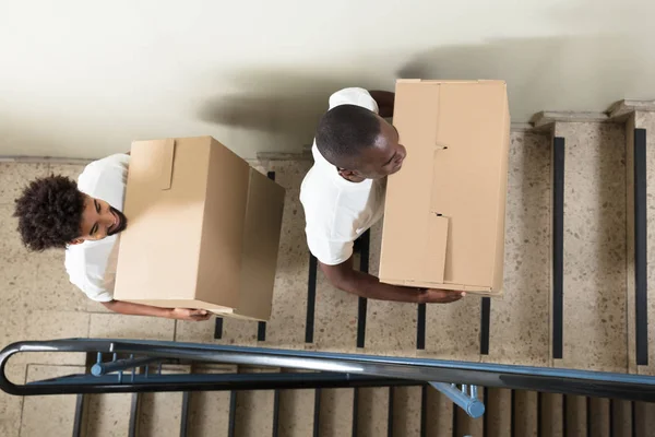 Portrait Two Young Smiling Movers Standing Staircase Holding Cardboard Boxes — Stock Photo, Image