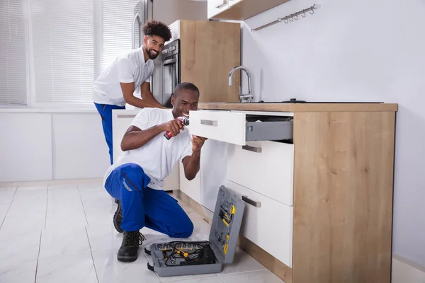 Rear View Two Happy Young Handy Men Fixing Wooden Cabinet — Stock Photo, Image