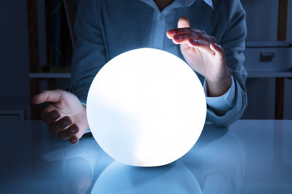 Portrait Of A Afro American Businesswoman Hands On Crystal Ball In Office