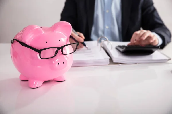 Close Pink Piggybank Wearing Spectacles Front Businessperson Calculating Bill — Stock Photo, Image