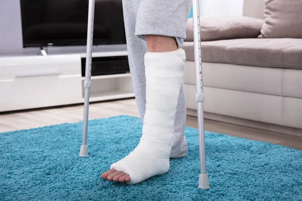Man Broken Leg Using Crutches Walking Blue Carpet — Stock Photo, Image