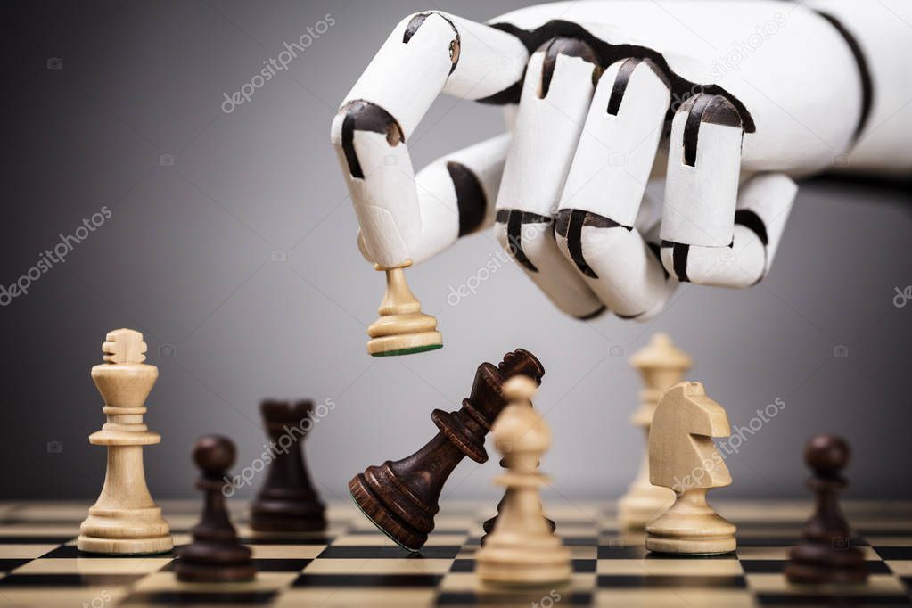 Close-up Of A Robot's Hand Playing Chess