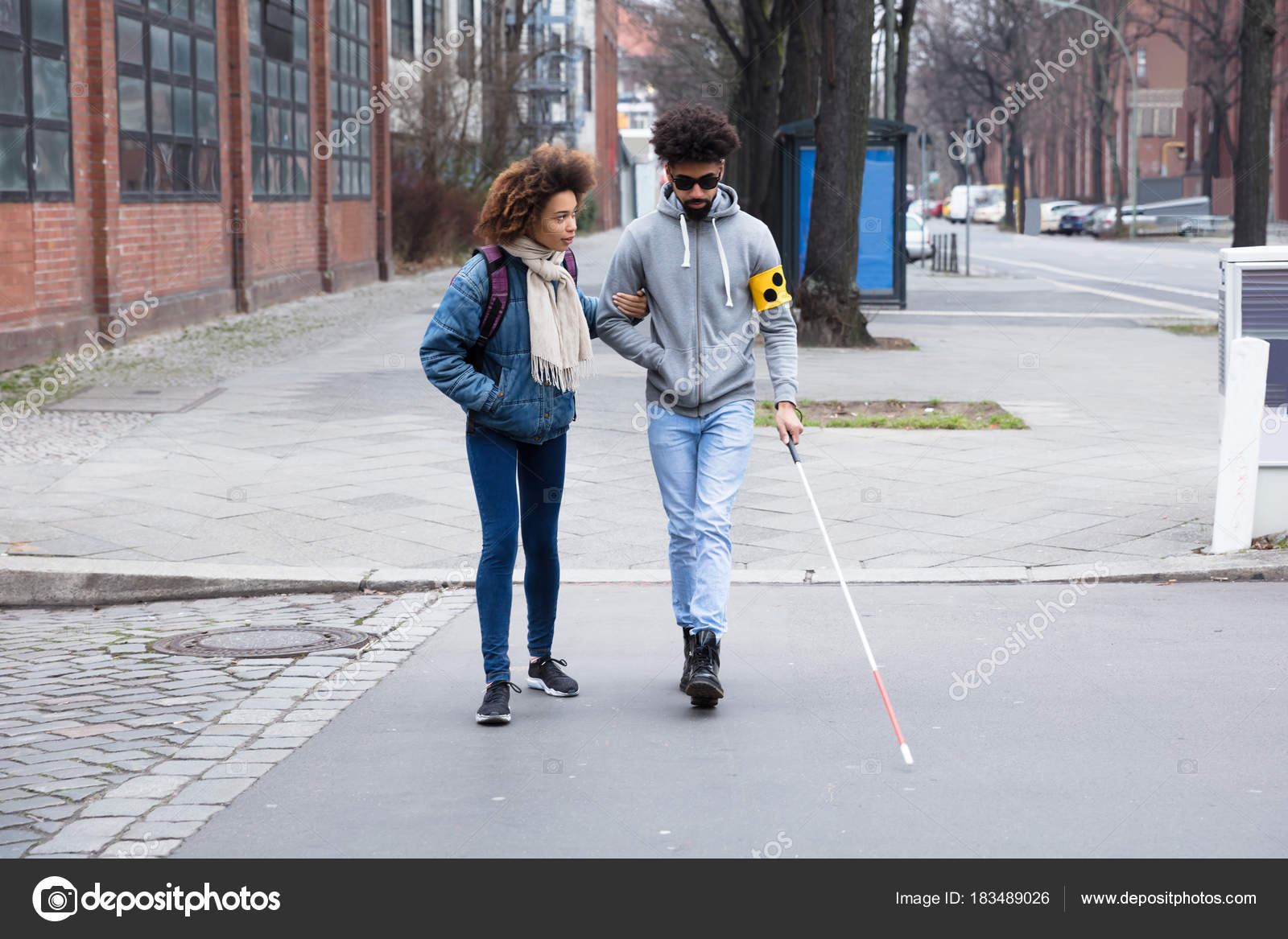 Young Woman Helping Blind Man White Stick While Crossing Road Stock