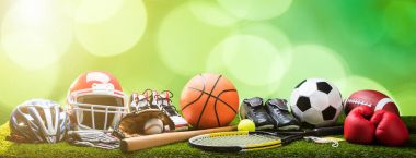 Close-up Of Various Sport Equipments On Pitch Against Bokeh Background clipart