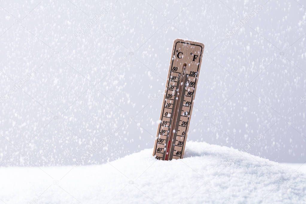 Thermometer On Snow Showing Low Temperature In Heavy Snowfall