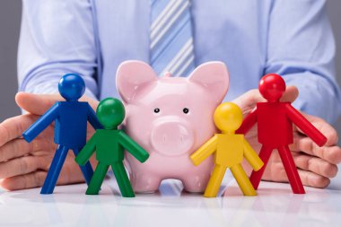 Bir kişinin el servet ve çok renkli insan figürleri koruma Close-Up