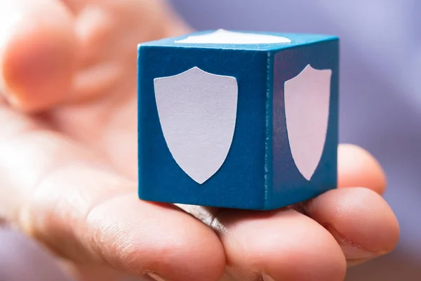 Close Hand Holding Blue Wooden Block White Security Shield Symbol — Stock Photo, Image