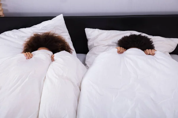 Elevated View Couple Covering Face White Sheet Bedroom — Stock Photo, Image