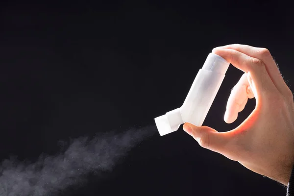 Person Using Asthma Inhaler Black Background — Stok Foto