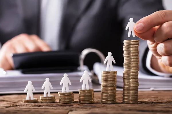 Human Hand Placing Small Human Figure Increasing Stacked Coins Wooden — Stock Photo, Image