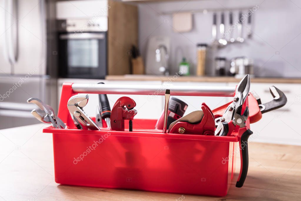 Toolbox With Different Worktools On Wooden Desk