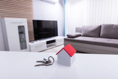 Close-up Of House Model And Key On White Desk In Living Room clipart