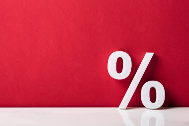 Close-up Of A Percentage Sign Leaning On Red Wall clipart