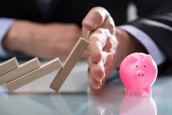 Close Businessman Hand Stopping Wooden Blocks Falling Piggybank Desk — Stock Photo, Image