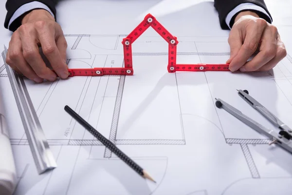 Architect Hand Holding House Made Red Measuring Tape Blueprint — Stock Photo, Image