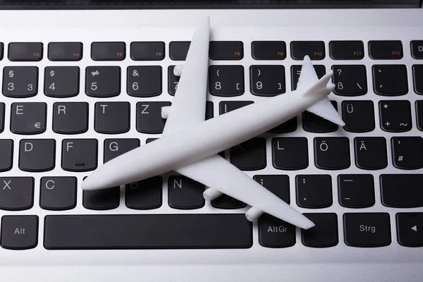 Erhöhte Ansicht Der Weißen Flugzeug Miniatur Auf Der Laptop Tastatur — Stockfoto