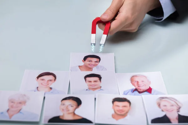 Close Businessperson Hand Horseshoe Magnet Attracting Photograph Smiling People — Stock Photo, Image