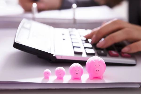 Nahaufnahme Eines Rosafarbenen Sparschweins Vor Geschäftsleuten Mit Taschenrechner — Stockfoto