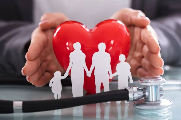 Close Stethoscope Family Figure Cut Out Front Businessperson Protecting Red — Stock Photo, Image