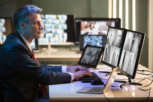 Side View Mature Businessman Looking Cctv Camera Footage Multiple Computer — Stock Photo, Image