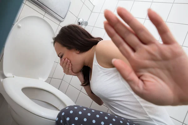 Close Young Woman Showing Stop Sign While Vomiting Toilet Bowl — Stock Photo, Image