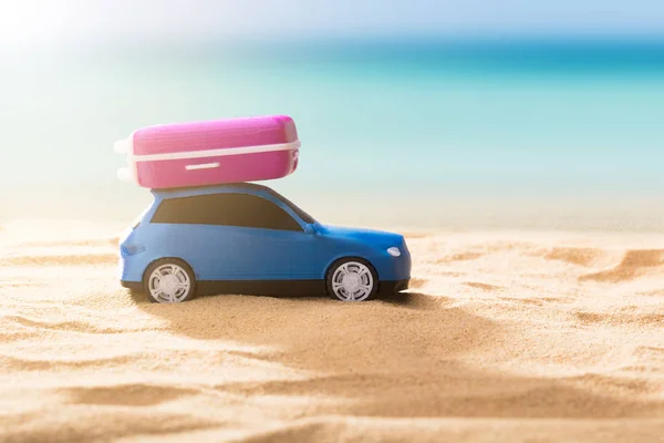 Close-up Of A Blue Car With Luggage On Sunny Day