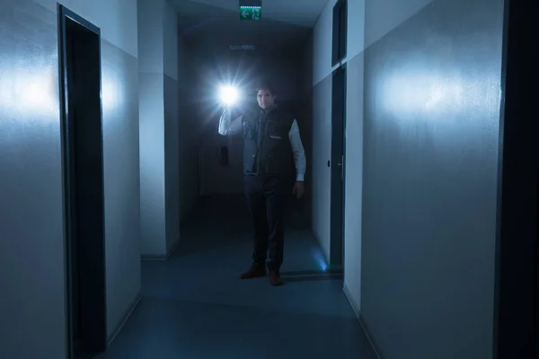 Male Security Guard Holding Flashlight Standing Corridor Building — Stock Photo, Image