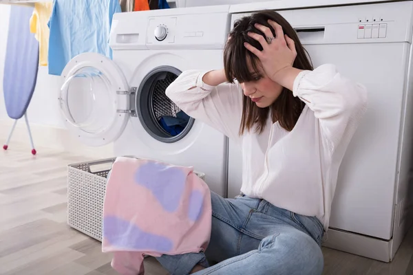 Upset Young Woman Looking Stained Cloth Laundry Room — Stock Photo, Image