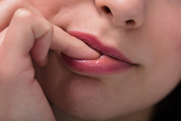 Close-up Of A Businesswoman Biting Her Fingernail